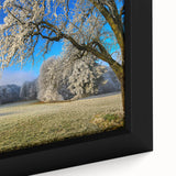 Framed canvas wall art showcasing a vibrant landscape of rolling green fields under a blue sky, emphasizing texture and color, perfect for home decor.