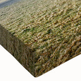 Close-up of a stretched canvas wall art piece showcasing a vibrant landscape field design with rich greens and blues, perfect for home decoration.