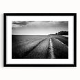Framed black wall art featuring a serene landscape of rolling green fields, elegantly matted to enhance depth, ideal for modern home decor.