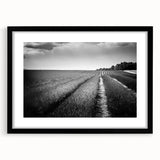 Framed black wall art featuring a serene landscape of rolling green fields, elegantly matted to enhance depth, ideal for modern home decor.