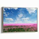 Framed canvas wall art showcasing a serene landscape with lush green fields and rolling hills, accented by a sleek silver frame, ideal for modern decor.