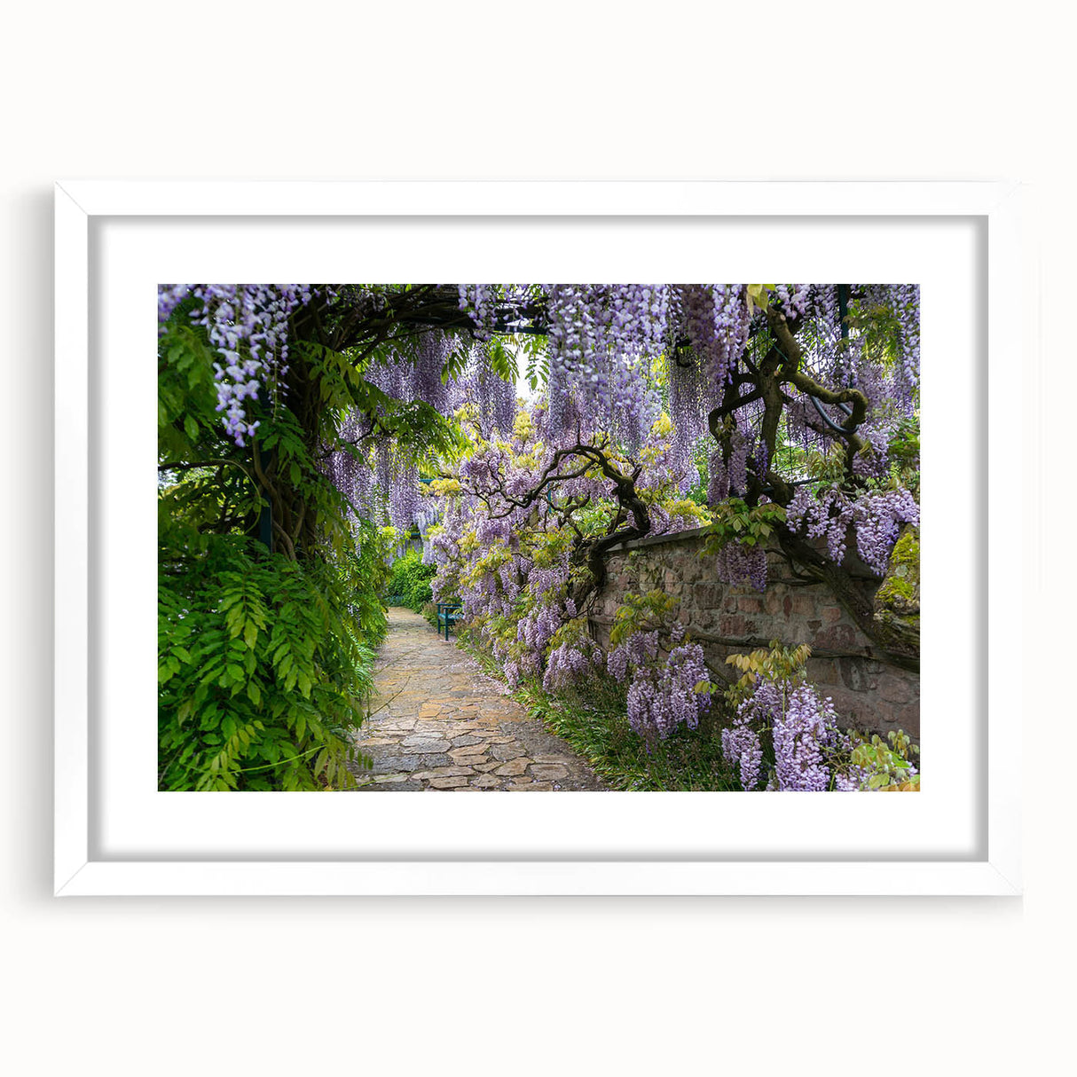 Framed wall art design showcasing a vibrant landscape garden scene with lush greenery and colorful flowers, set in a sleek white frame with a mat for added elegance.
