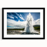 Framed landscape wall art showcasing a vibrant geyser design, featuring a sleek black frame and white mat, perfect for modern home decor.