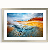 Framed wall art featuring a stunning geyser landscape design, showcasing vibrant colors and intricate details, complemented by a silver mat for an elegant presentation.