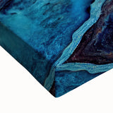 Close-up of a stretched canvas wall art featuring a vibrant geyser landscape design, showcasing bold colors and intricate details, perfect for modern home decor.