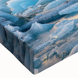 Close-up of a stretched canvas artwork showcasing a vibrant glacier landscape design, featuring icy blues and whites, perfect for modern home decor.