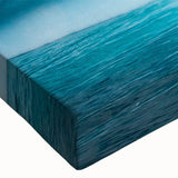 Close-up of a stretched canvas wall art piece depicting a stunning glacier landscape, showcasing vibrant blues and whites, perfect for home decor.