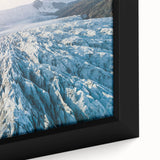 Framed canvas art showcasing a stunning close-up of a glacier landscape design, featuring vibrant blues and whites, perfect for adding a serene touch to home decor.