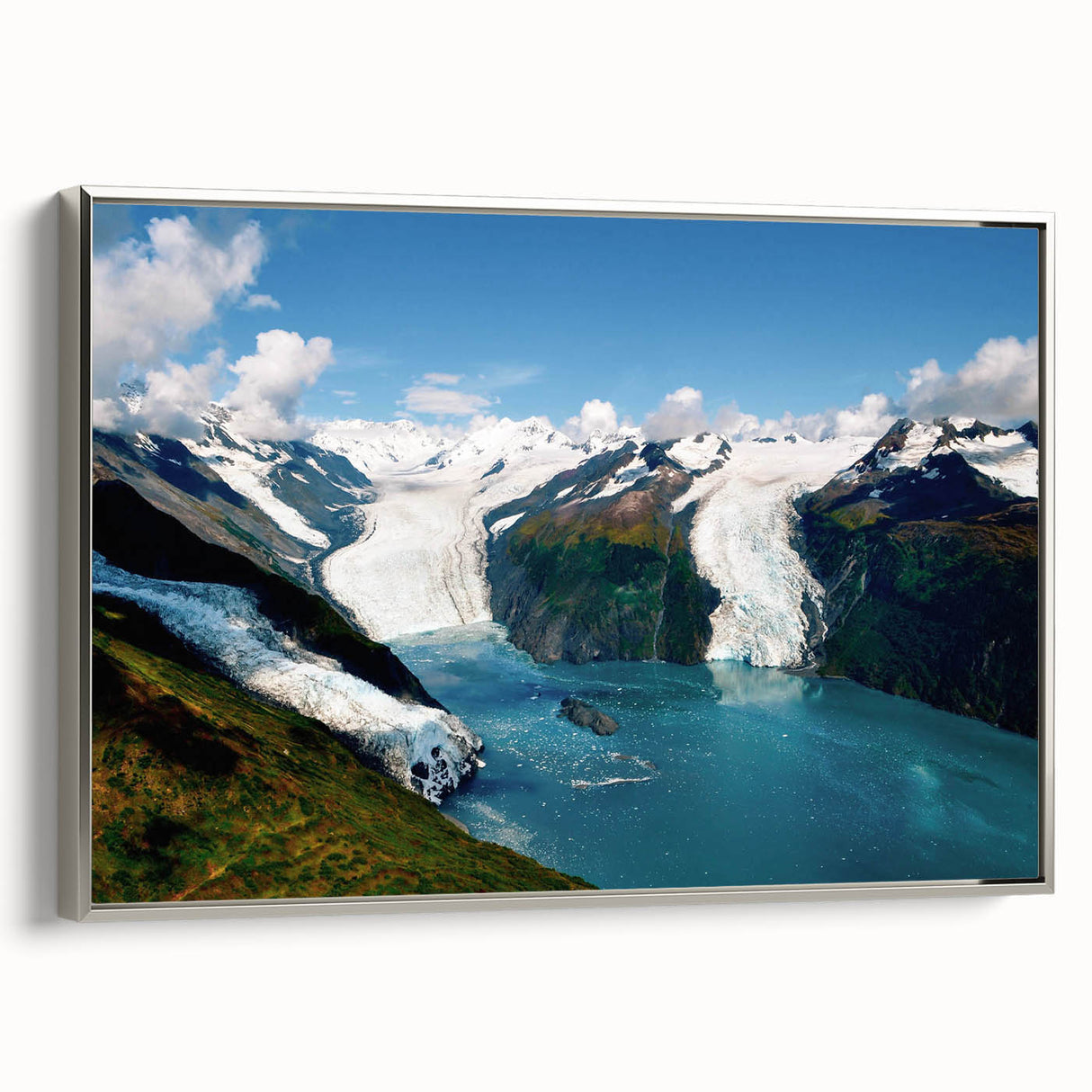 Framed canvas wall art showcasing a stunning glacier landscape design, featuring icy blues and whites, elegantly displayed with a silver frame, perfect for modern decor.