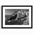 Framed black wall art featuring a serene harbor landscape design, accented by a white mat, perfect for modern home decor and enhancing interior aesthetics.