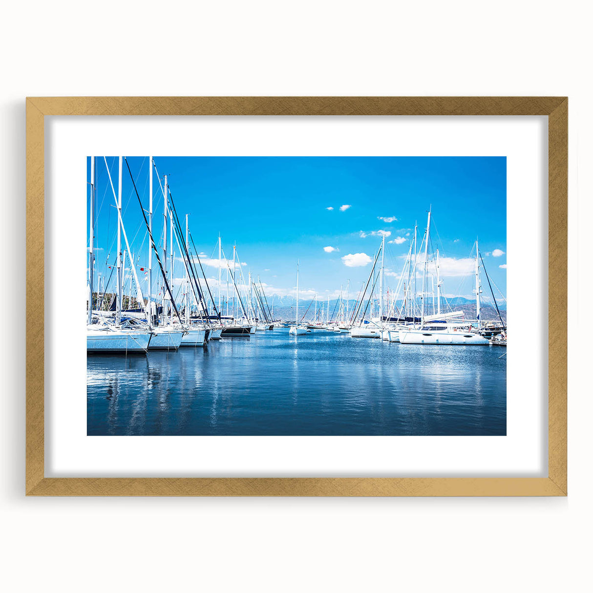 Elegant wall art frame showcasing a coastal harbor landscape design with a gold mat, perfect for enhancing home decor in living spaces or offices.