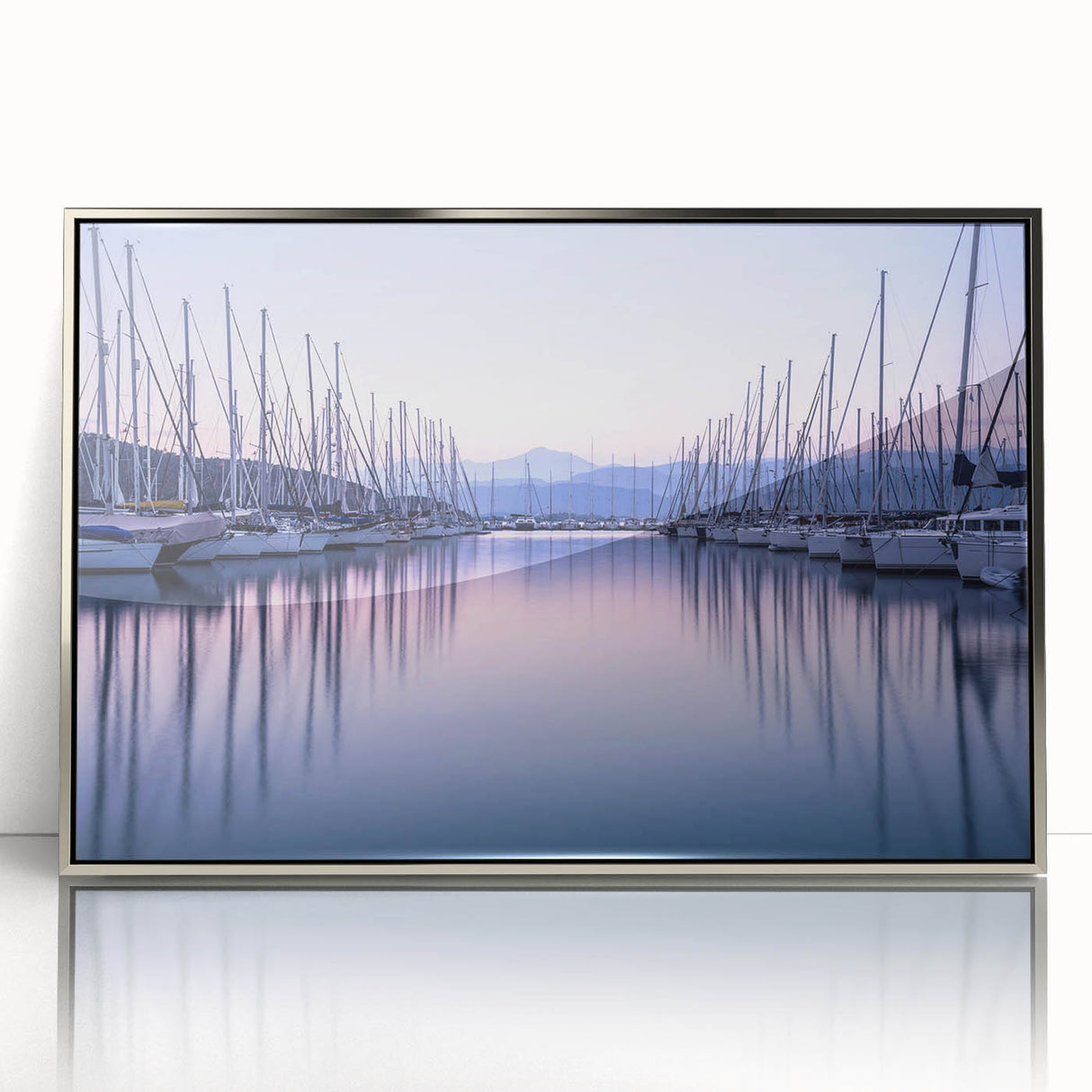 Framed acrylic wall art collection featuring a serene harbor landscape design, showcasing soft blue and green hues with a sleek silver frame, perfect for modern decor.