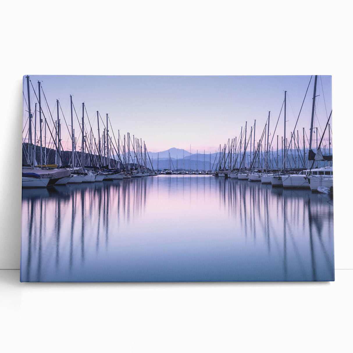 Vibrant landscape harbor design canvas art, featuring serene blue waters and a sunset sky, elegantly leaning against a wall for a stylish decor accent. Perfect for enhancing home or office interiors with a touch of nature-inspired beauty.