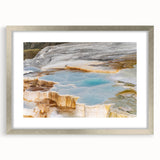 Framed wall art depicting serene hot spring landscapes, featuring vibrant colors and intricate details, set in a sleek silver frame with a mat for an elegant touch. Perfect for enhancing home décor with a nature-inspired aesthetic.