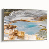 Framed canvas wall art showcasing a serene hot spring landscape, featuring vibrant greens and blues, accented with a sleek silver frame, ideal for home decor.