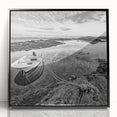 Framed acrylic wall art featuring a serene landscape of a lake surrounded by lush greenery and mountains, presented in a sleek black frame, ideal for home decor.