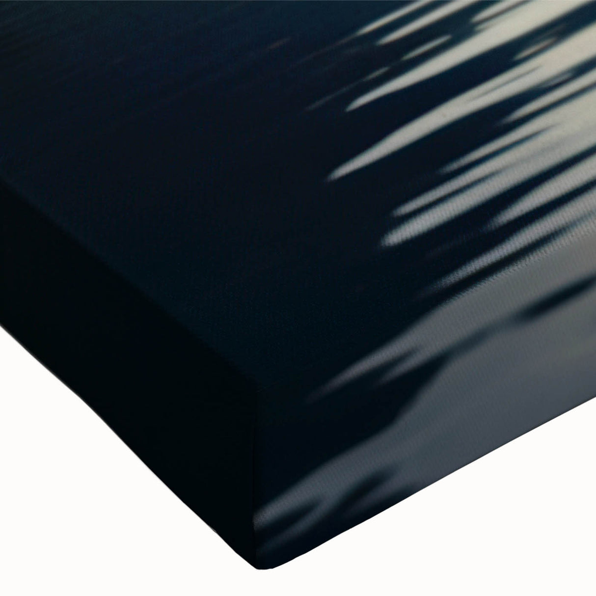 Close-up of a vibrant stretched canvas wall art piece depicting serene lakeside landscapes with rich blues and greens, ideal for enhancing home decor.