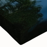 Close-up of a stretched canvas print showcasing a serene lake landscape with vivid blues and greens, ideal for enhancing home decor and creating a calming atmosphere.