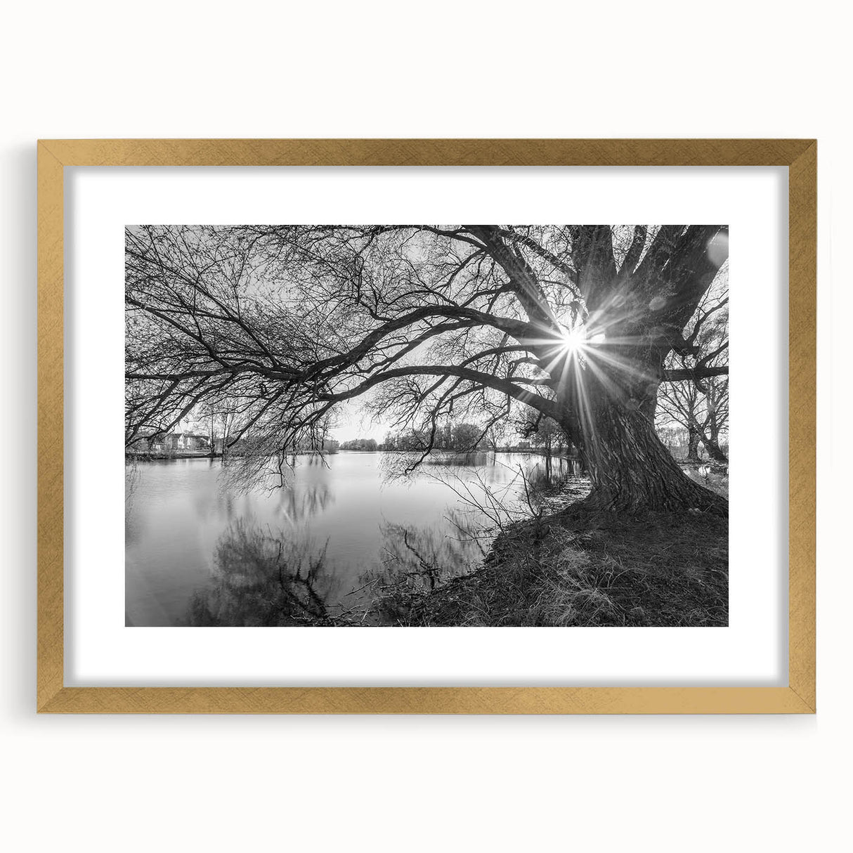 Framed wall art featuring a serene landscape of lakes, highlighted by a gold frame and mat, perfect for enhancing home decor with nature-inspired elegance.