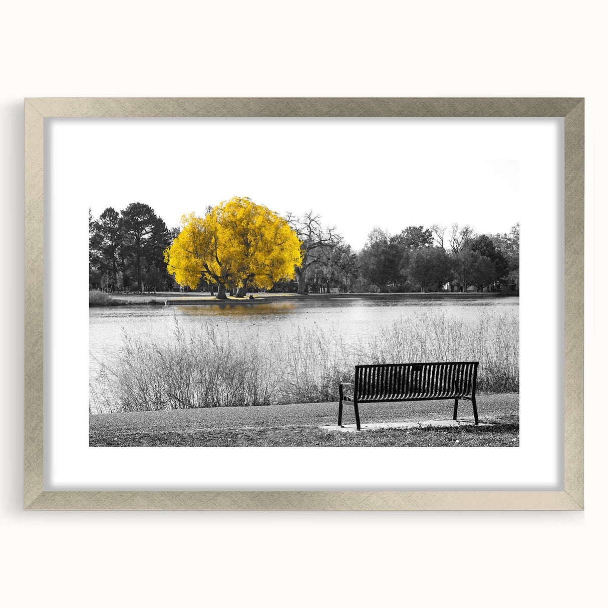 Framed wall art showcasing a serene lake landscape with lush greenery, elegantly presented in a silver frame with a mat, perfect for enhancing home decor.