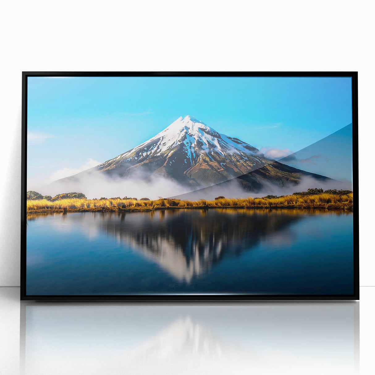 Framed wall art featuring a serene lake landscape, highlighted by tranquil blue and green tones, encased in a sleek black frame for modern decor. Ideal for enhancing living spaces and promoting relaxation.