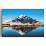Stretched canvas wall art showcasing a serene lake landscape with lush greenery and a clear blue sky, designed to enhance home decor and evoke tranquility.