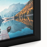 Framed canvas artwork showcasing a serene lake landscape with vibrant blue waters and lush green trees, adding a tranquil ambiance to home decor.