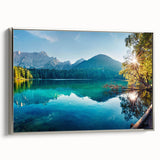 Framed canvas wall art showcasing a serene landscape with a tranquil lake, surrounded by lush greenery, highlighted by a stylish silver frame, perfect for home decor.