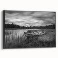Framed canvas wall art showcasing a serene lake landscape design with rich blues and greens, displayed at a slight angle to highlight its black frame and textured surface. Perfect for modern home decor.