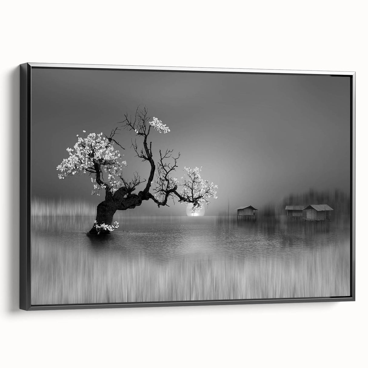 Framed canvas wall art showcasing a serene lake landscape with lush greenery and a vibrant sunset, viewed from the side in a sleek black frame. Perfect for enhancing home decor.