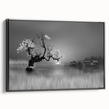 Framed canvas wall art showcasing a serene lake landscape with lush greenery and a vibrant sunset, viewed from the side in a sleek black frame. Perfect for enhancing home decor.
