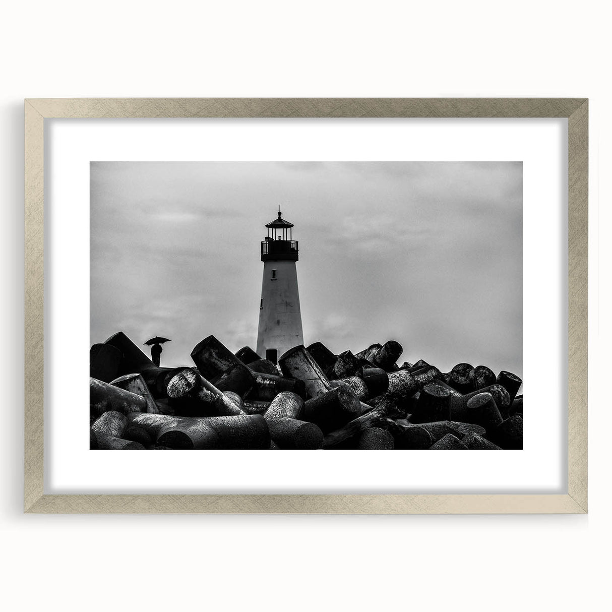 Framed wall art featuring a serene lighthouse landscape design, showcasing a silver frame with a mat, ideal for coastal-themed decor or home accents.