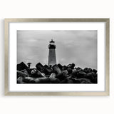 Framed wall art featuring a serene lighthouse landscape design, showcasing a silver frame with a mat, ideal for coastal-themed decor or home accents.