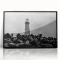 Framed wall art featuring a coastal lighthouse design, showcasing vibrant colors and intricate details in a black frame, perfect for home decor enthusiasts.