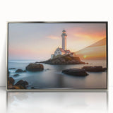 Framed wall art featuring a stunning lighthouse design, set against a serene landscape with vibrant colors, showcased in a sleek silver frame for modern decor.