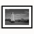 Framed wall art collection showcasing a serene lighthouse landscape design with a black mat and frame, perfect for coastal-themed decor.