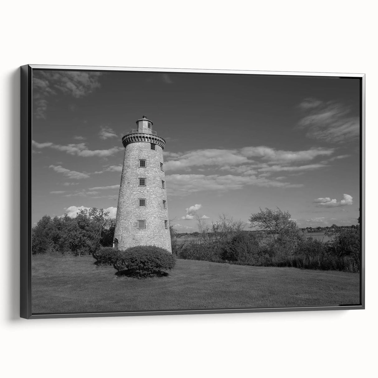 Framed canvas wall art featuring a scenic lighthouse design with vibrant colors, black frame, and side view showcasing the artwork's depth and texture, ideal for home decor.