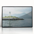 Framed wall art featuring a stunning lighthouse design set against a vibrant coastal landscape, with a sleek black frame enhancing its modern aesthetic. Perfect for nautical-themed decor or coastal living spaces.