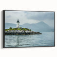 Framed canvas wall art showcasing a serene coastal landscape with a lighthouse, featuring a black frame and vibrant colors, ideal for home decor enhancement.