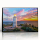 Framed wall art showcasing a striking lighthouse design with vibrant colors, set against a serene landscape, perfect for nautical-themed home decor.