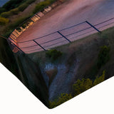 Close-up of a stretched canvas wall art piece showcasing a vibrant lighthouse design, featuring blues and whites against a serene coastal landscape, perfect for nautical-themed decor.