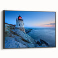 Framed canvas wall art showcasing a serene lighthouse landscape design with a black frame, ideal for enhancing coastal-themed decor and interior spaces.