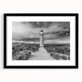 Black framed wall art collection featuring vibrant landscapes and a lighthouse design, ideal for home decor, enhancing coastal-themed interiors with a modern touch.