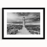 Black framed wall art collection featuring vibrant landscapes and a lighthouse design, ideal for home decor, enhancing coastal-themed interiors with a modern touch.