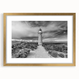 Framed wall art collection showcasing a serene lighthouse landscape design, featuring a gold mat and elegant frame, ideal for home decor enhancement.