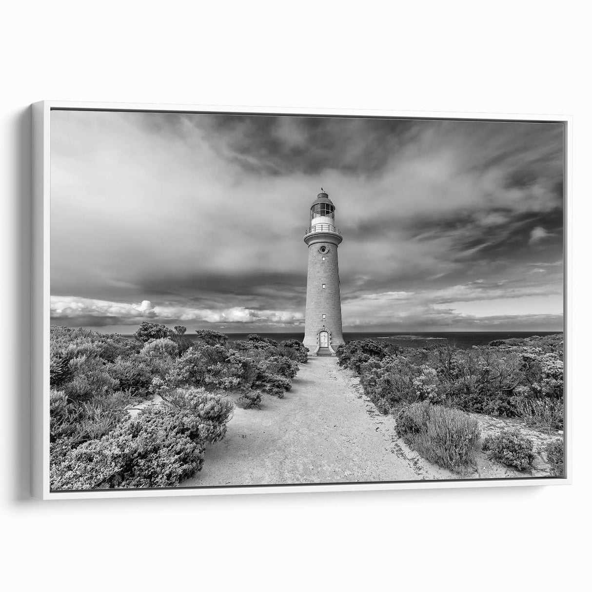 Framed canvas wall art collection featuring a serene lighthouse landscape design in soft pastel colors, showcasing a white frame and side view perspective, perfect for coastal-themed decor.