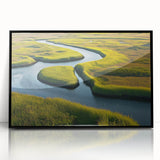 Framed wall art featuring a serene marsh landscape in soft green and blue tones, set in a sleek black frame, perfect for enhancing home decor with a nature-inspired touch.