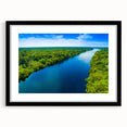 Framed wall art featuring a serene marsh landscape with lush greenery and calm water, presented in a sleek black frame with a mat, perfect for home decor.