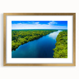 Framed wall art depicting a serene marsh landscape with lush greenery and reflective water, featuring a gold frame and mat, perfect for enhancing home decor.