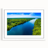 Framed wall art design showcasing a serene marsh landscape featuring lush greenery and tranquil water, presented in a sleek white mat for an elegant display.